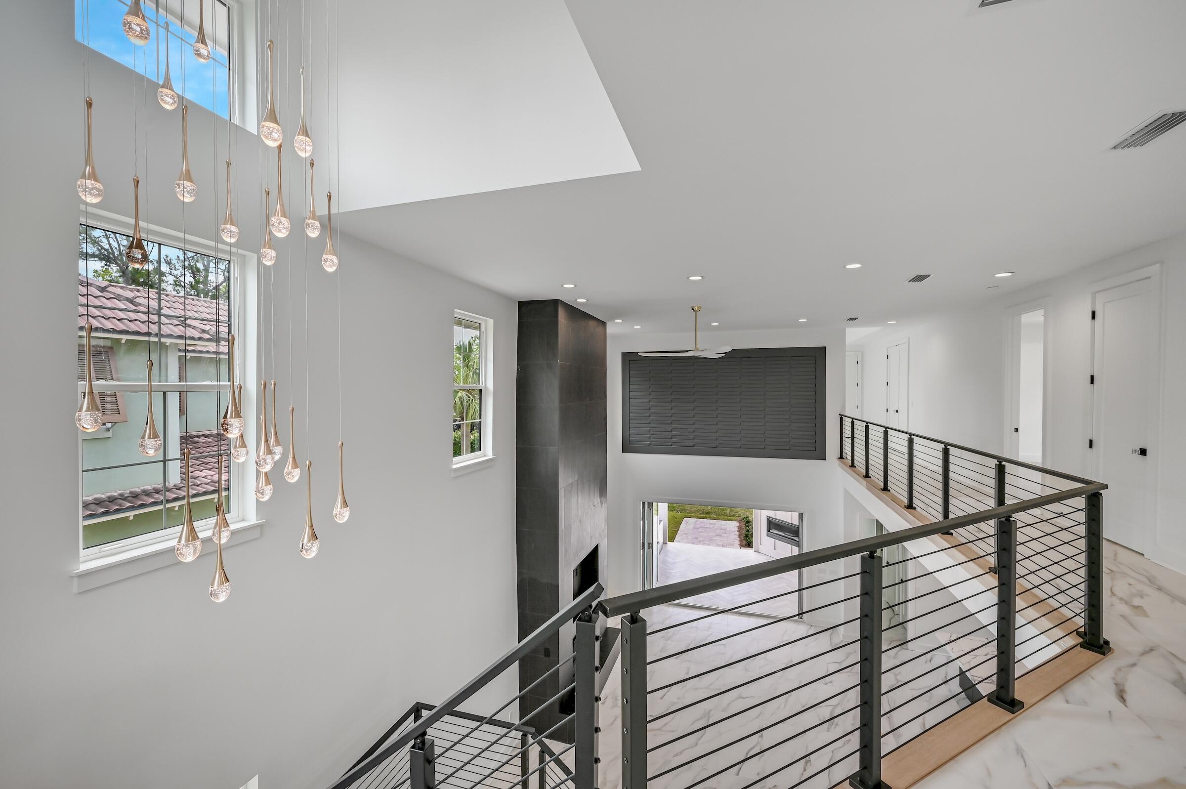 80 Rue Martine Miramar Beach, FL 32550 - Photo 36 of 54 a view of staircase with lots of frames on wall and windows