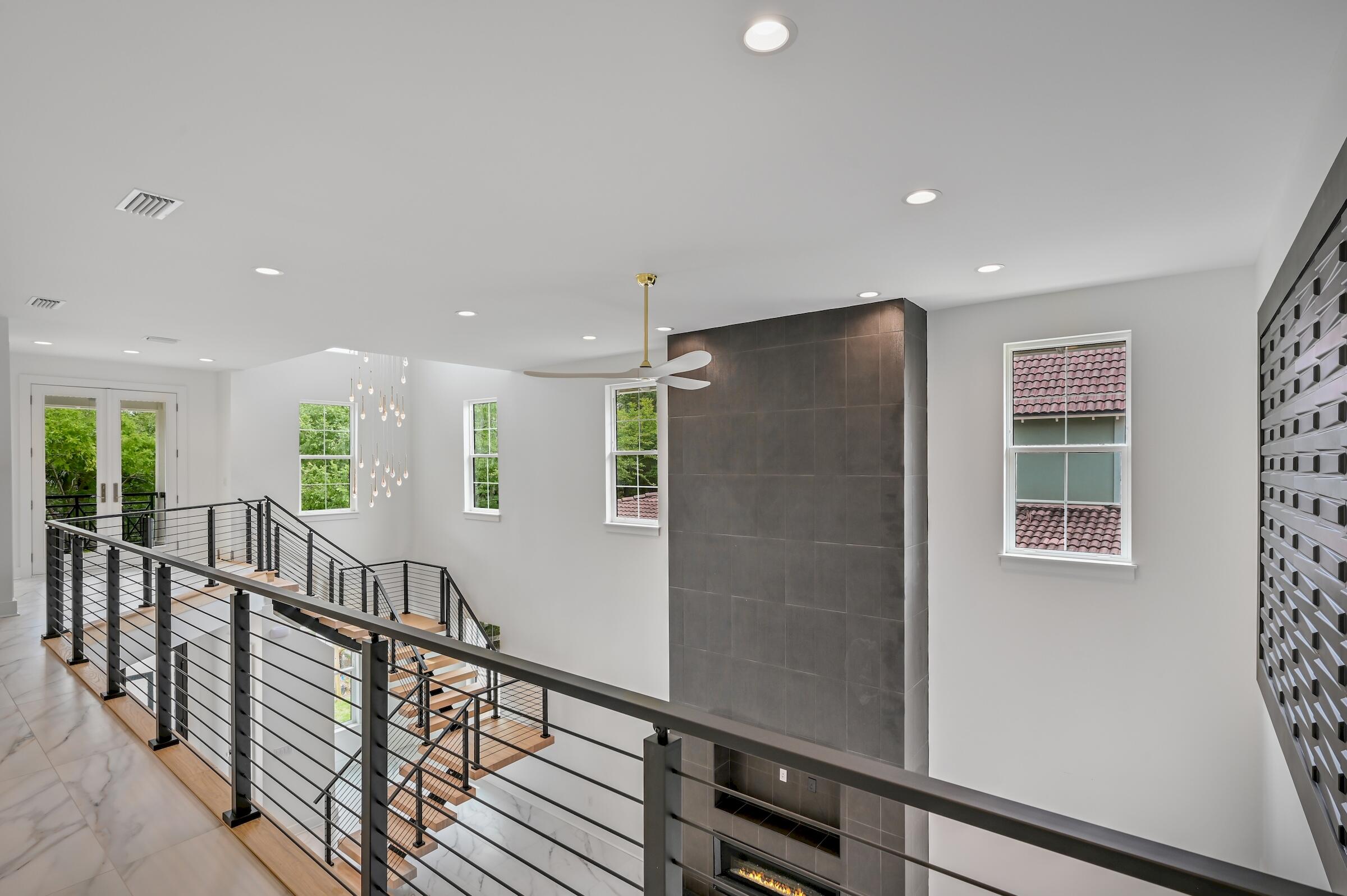 80 Rue Martine Miramar Beach, FL 32550 - Photo 37 of 54 a view of a hallway with wooden floor and stairs