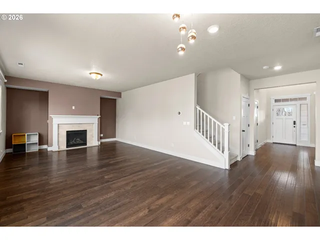 a view interior of a house with wooden floor fireplace and windows