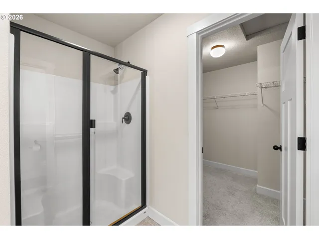 a bathroom with a shower and a glass door