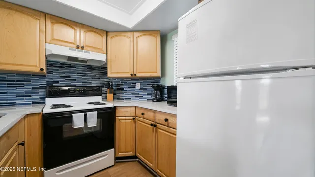 a kitchen with a sink and a refrigerator