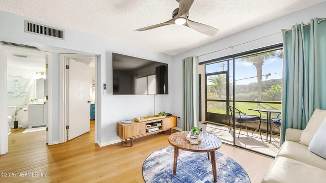 a living room with furniture and a floor to ceiling window