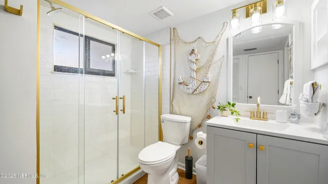 a bathroom with a granite countertop toilet sink and shower