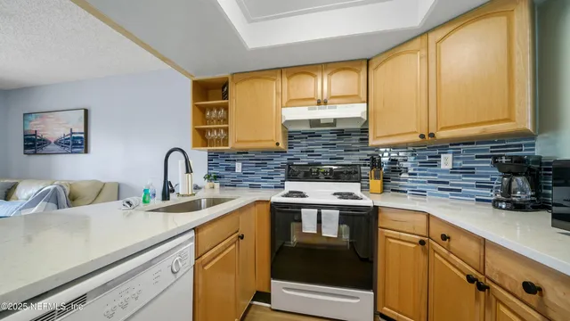 a kitchen with stainless steel appliances granite countertop a sink and cabinets