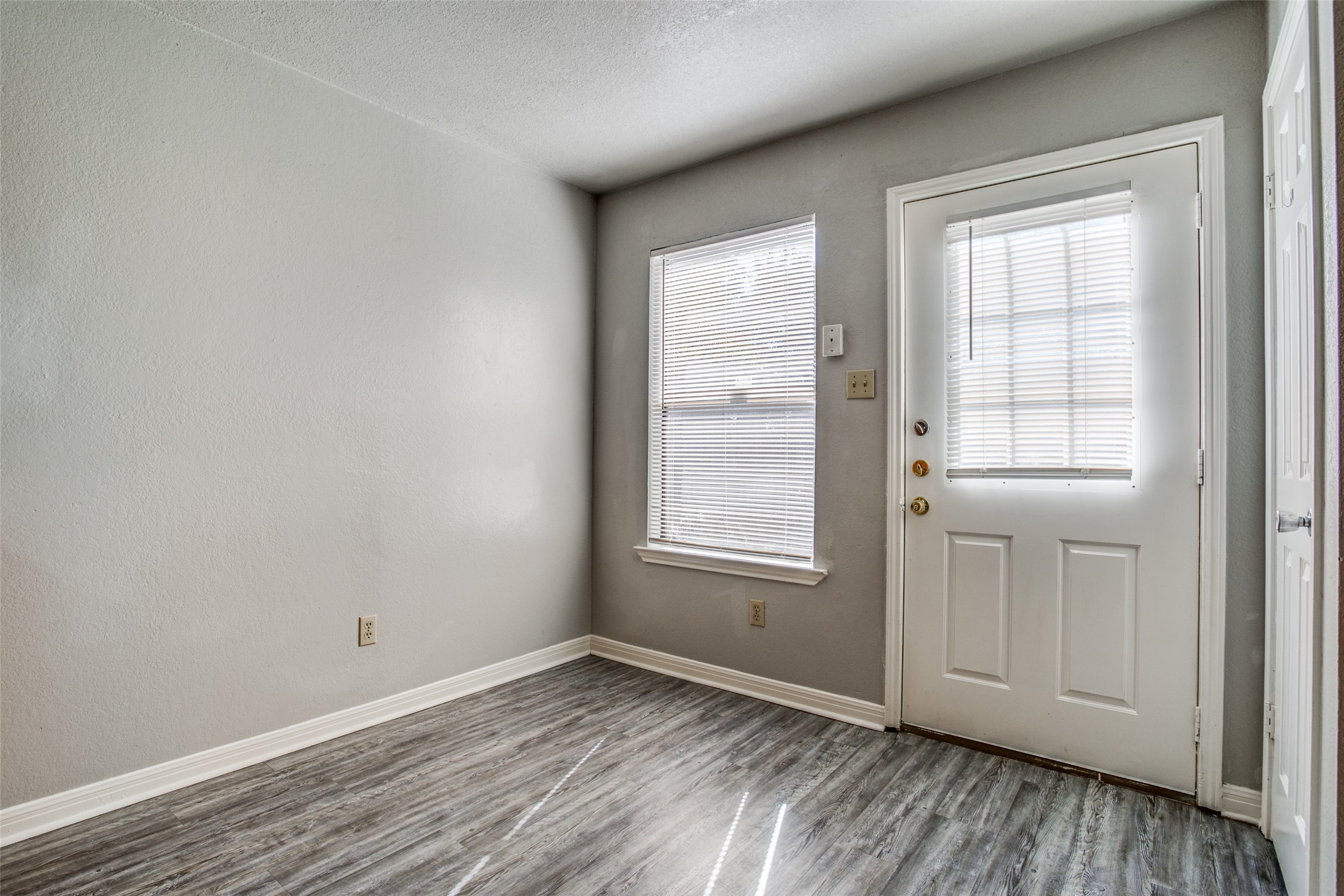 106 Verna Spur, Unit B Georgetown, TX 78628 - Photo 13 of 25 Wood-look flooring and well-lit walls create a versatile and inviting atmosphere.