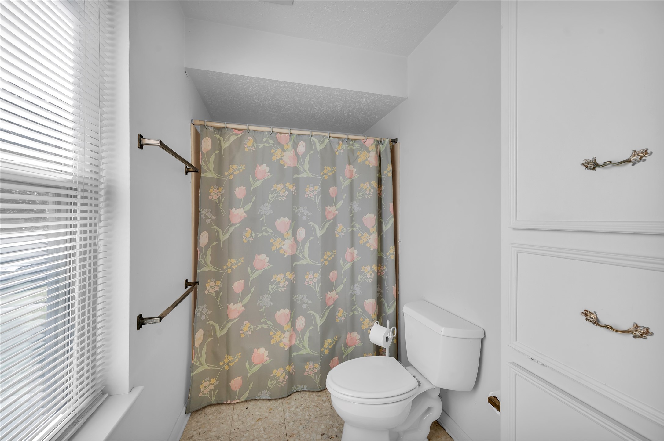 17903 Fireside Drive Spring, TX 77379 - Photo 23 of 33 a white toilet sitting next to a shower curtain