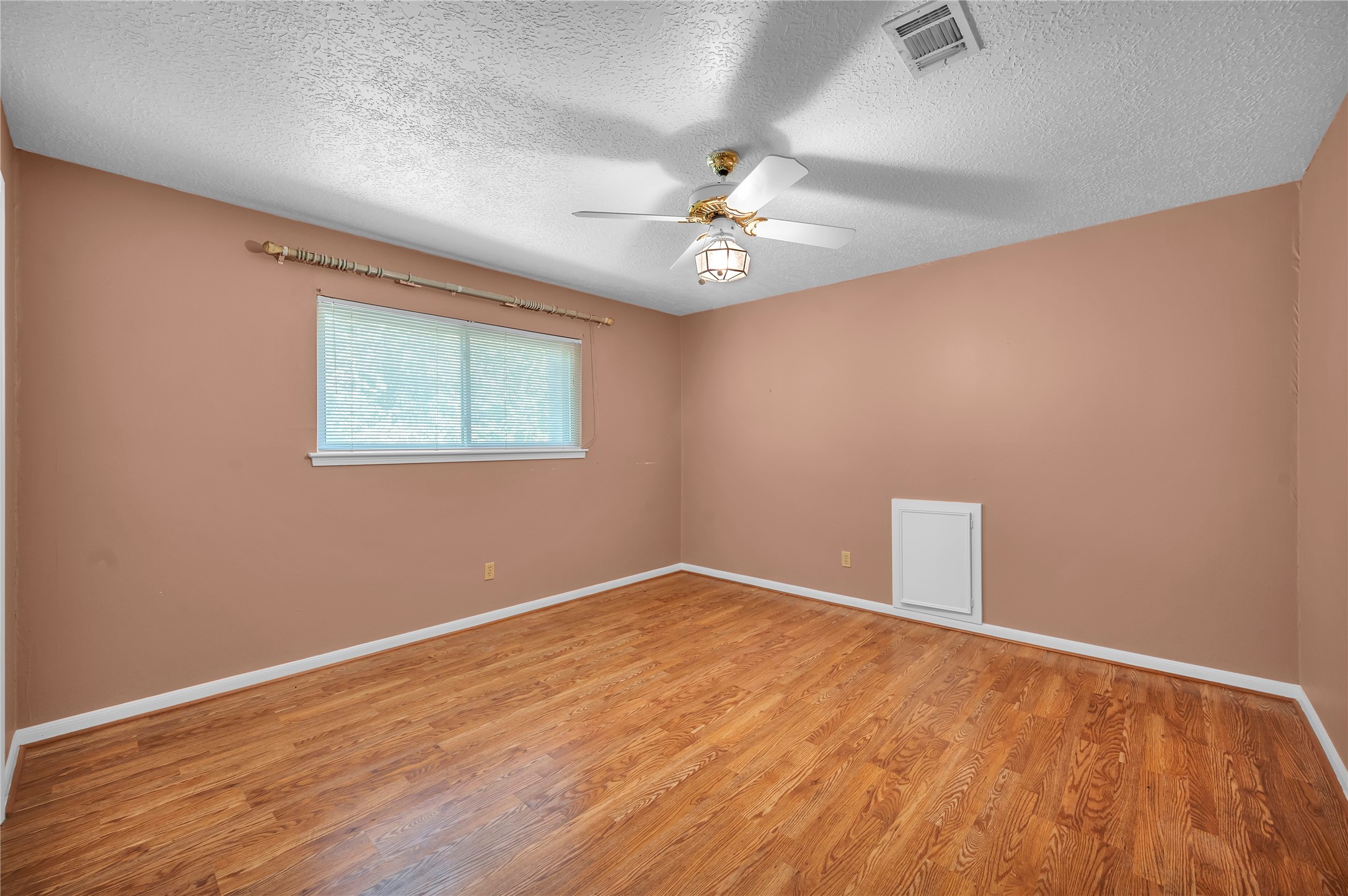 17903 Fireside Drive Spring, TX 77379 - Photo 24 of 33 an empty room with wooden floor chandelier fan and windows