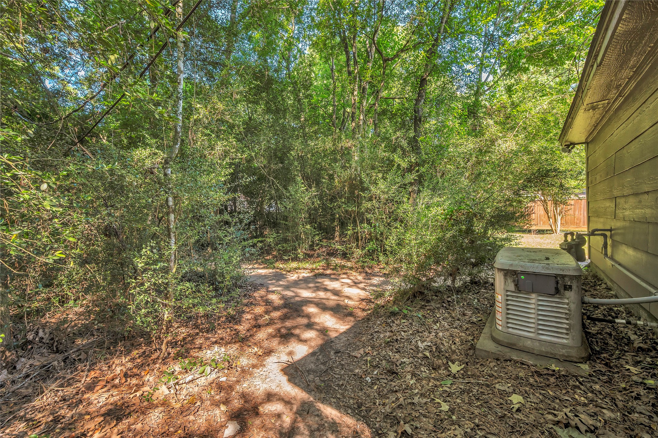 17903 Fireside Drive Spring, TX 77379 - Photo 30 of 33 a view of a yard with plants and wooden fence