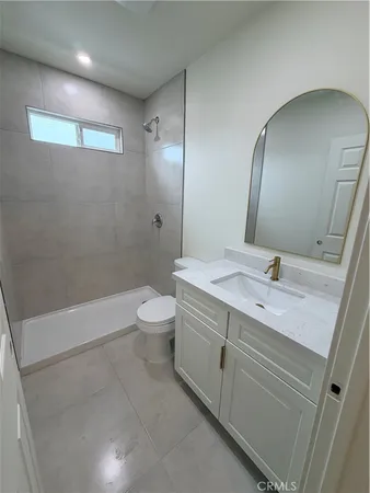 a bathroom with a double vanity sink toilet and shower