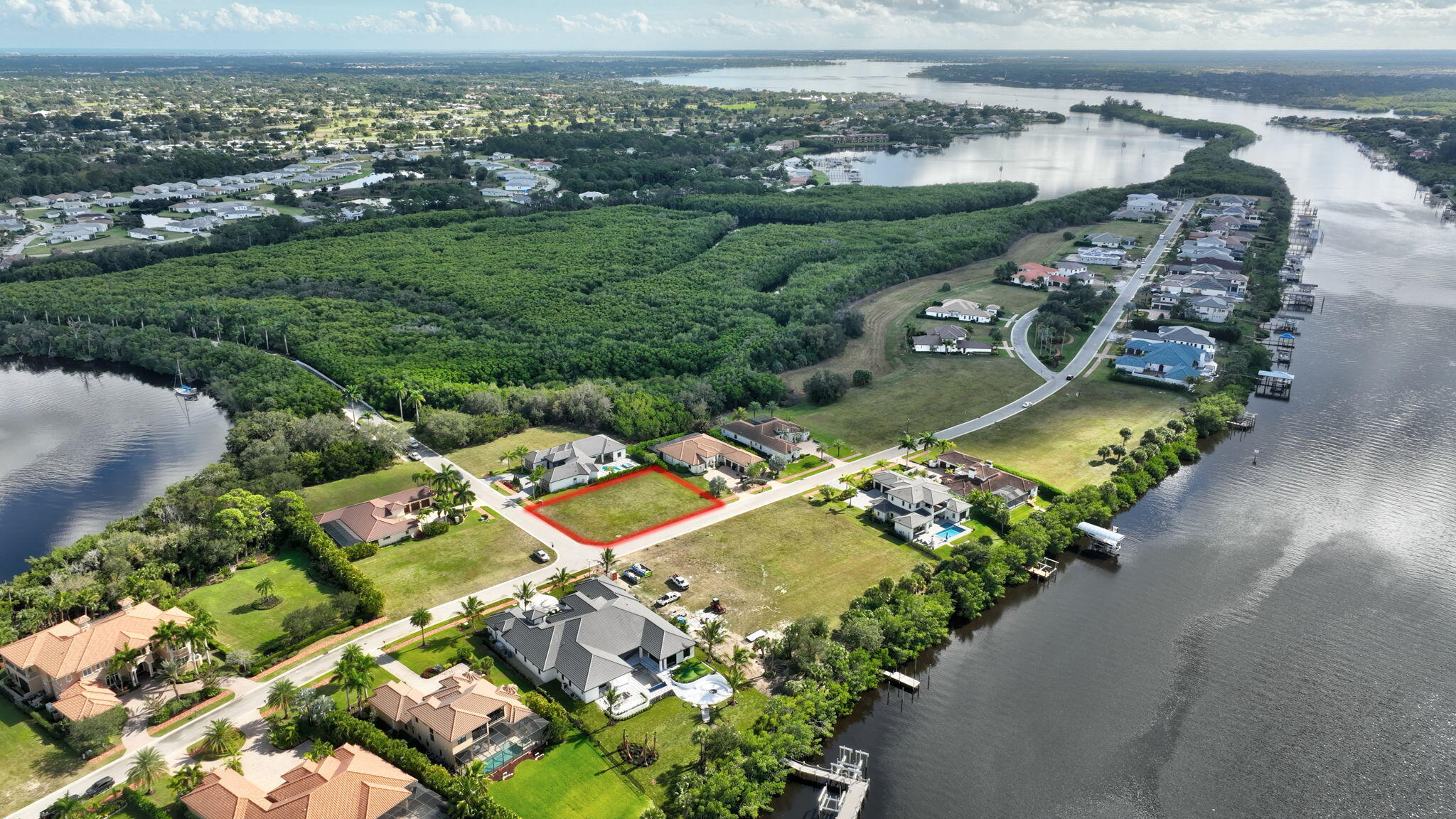 183 Southeast Via Terra Bella Port St. Lucie, FL 34952 - Photo 2 of 26 an aerial view of a city with lots of residential buildings ocean and mountain view in back