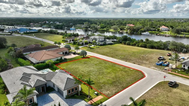 an aerial view of a house with a garden and lake view