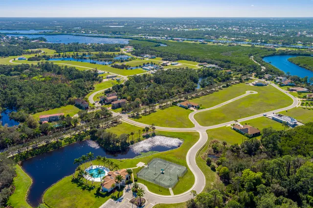 an aerial view of residential house with outdoor space swimming pool and ocean view