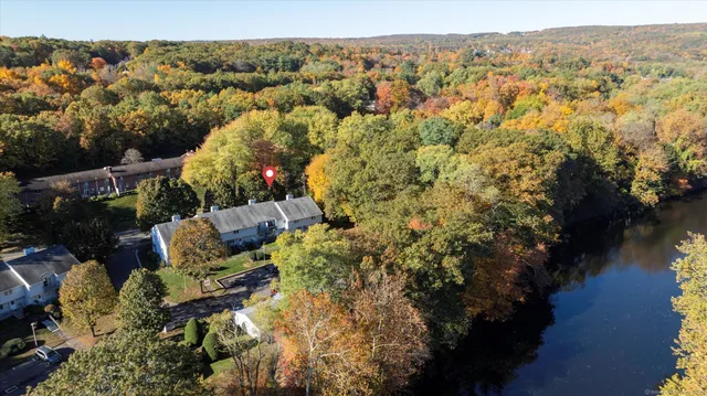 an aerial view of house with yard swimming pool and mountains