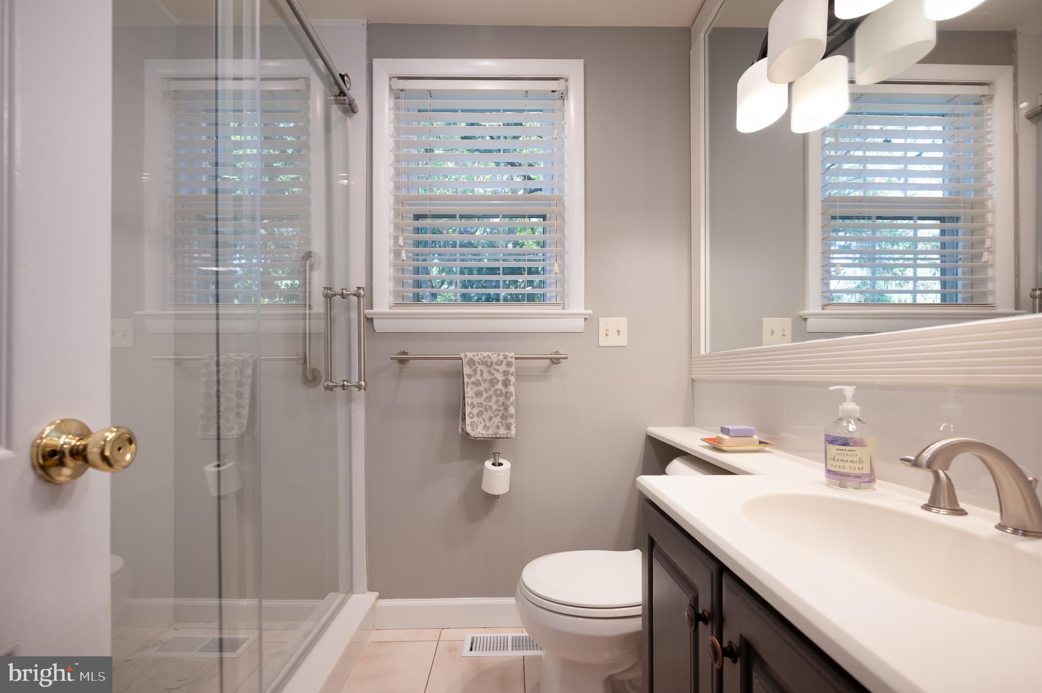 1822 Foulk Road Wilmington, DE 19810 - Photo 17 of 32 a bathroom with a sink vanity granite toilet and a shower