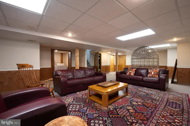 a living room with furniture and a rug