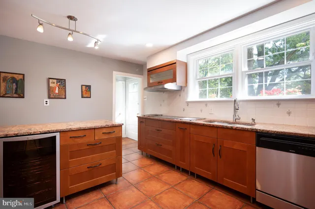 a kitchen with stainless steel appliances granite countertop a sink and a stove