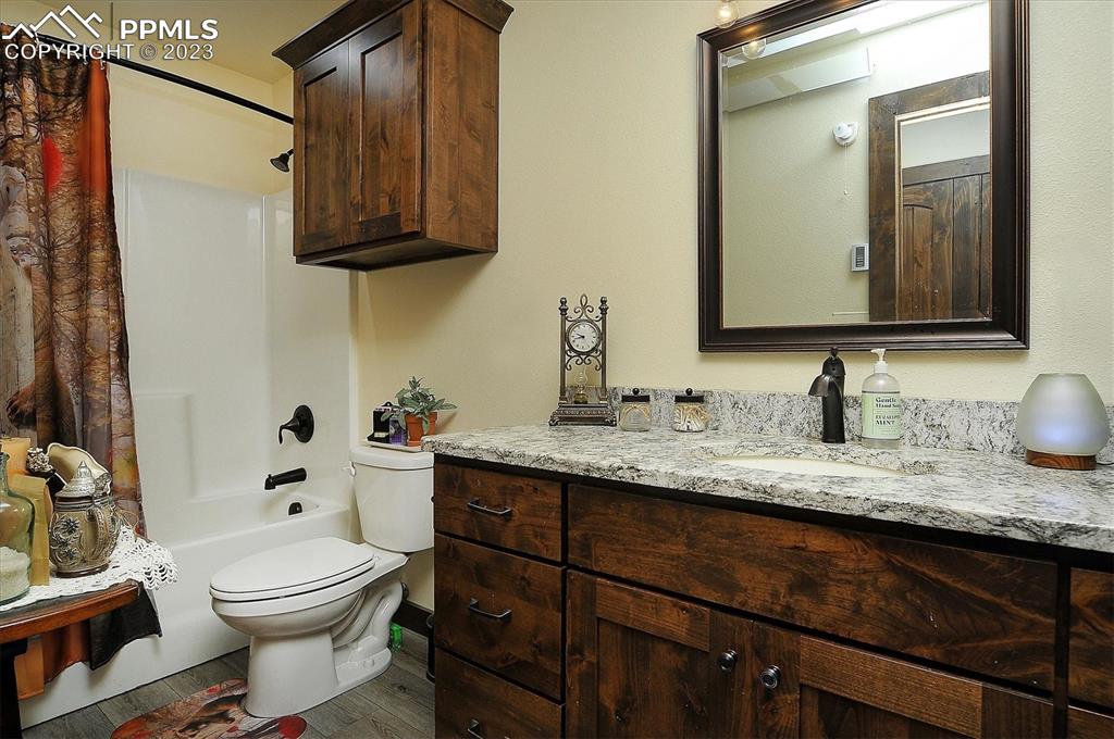 114 3rd Street Silver Cliff, CO 81252 - Photo 14 of 23 a bathroom with a granite countertop toilet sink and mirror