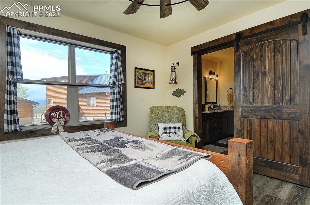 114 3rd Street Silver Cliff, CO 81252 - Photo 17 of 23 a bedroom with a bed and chair
