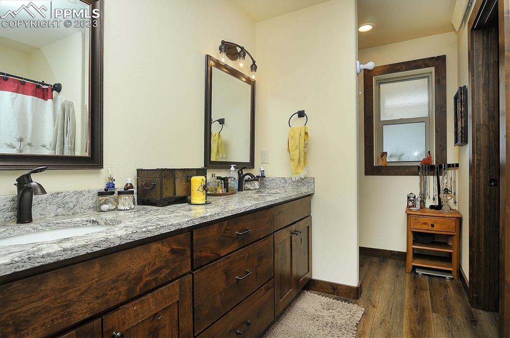 114 3rd Street Silver Cliff, CO 81252 - Photo 18 of 23 a bathroom with a granite countertop sink and a mirror