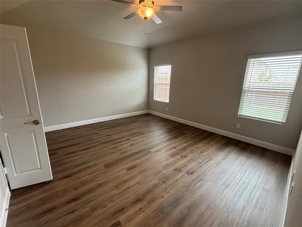 1510 Crystal Vly Way Melissa, TX 75454 - Photo 12 of 24 an empty room with wooden floor and windows
