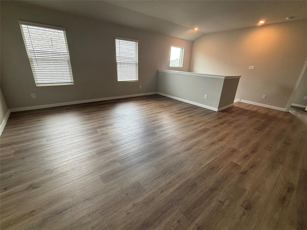 1510 Crystal Vly Way Melissa, TX 75454 - Photo 17 of 24 an empty room with wooden floor and windows
