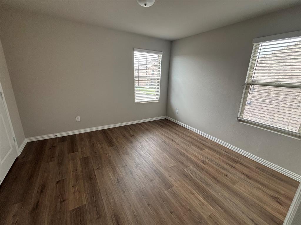 1510 Crystal Vly Way Melissa, TX 75454 - Photo 19 of 24 a view of an empty room with wooden floor and a window