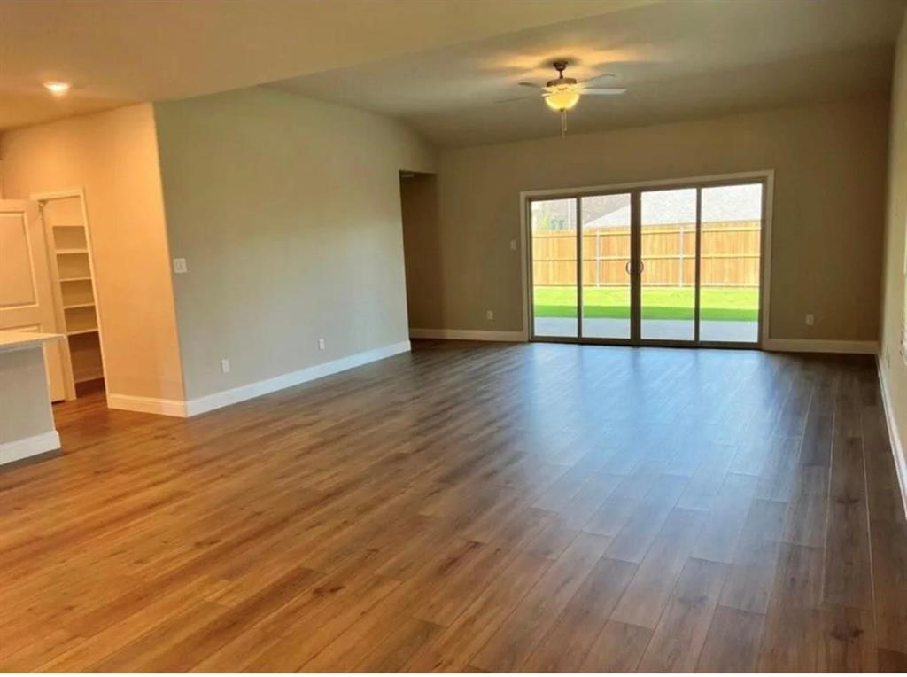 1510 Crystal Vly Way Melissa, TX 75454 - Photo 5 of 24 an empty room with wooden floor and windows