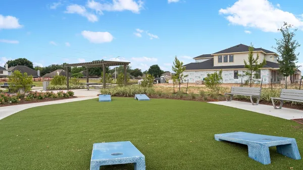 a view of a terrace with a garden and outdoor seating