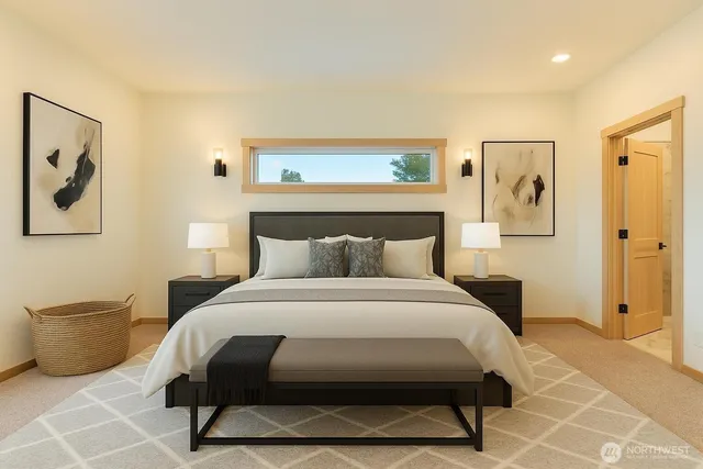 a bedroom with a bed and a painting on the wall