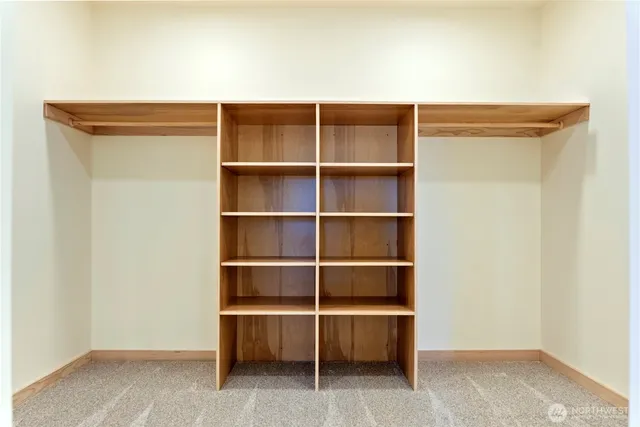 a living room with a shelf and a table