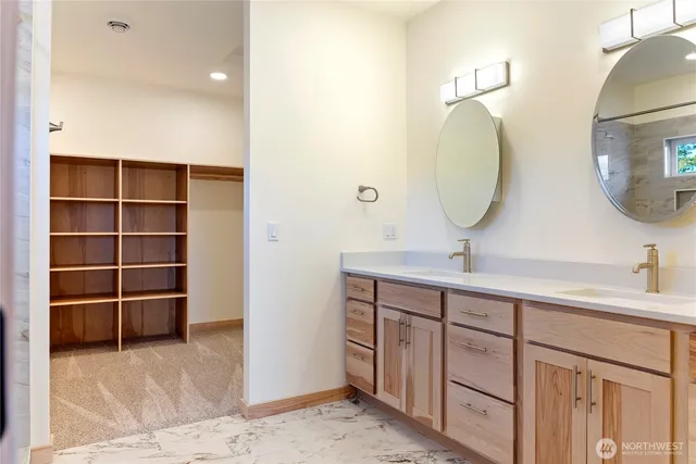 a bathroom with a double vanity sink and a mirror