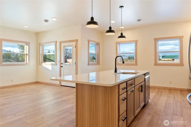 a kitchen with sink and wooden floor