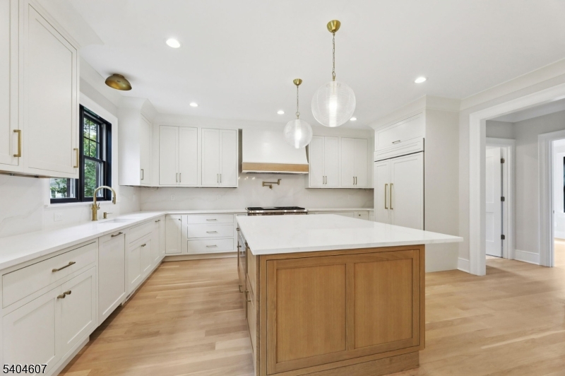 25 Beverly Road Madison, NJ 07940 - Photo 11 of 47 a large kitchen with stainless steel appliances kitchen island granite countertop a sink a stove and a refrigerator