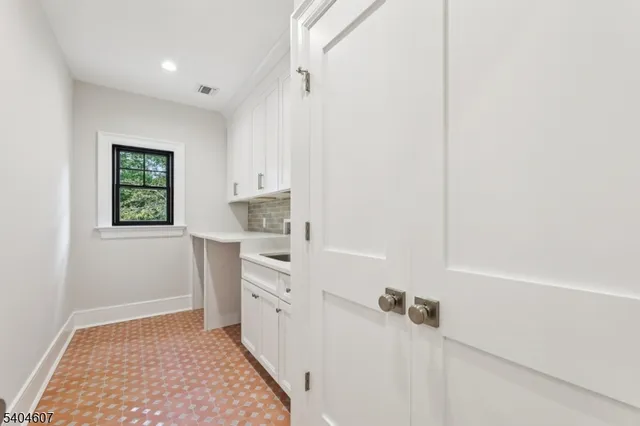 a bathroom with a sink a window and a shower