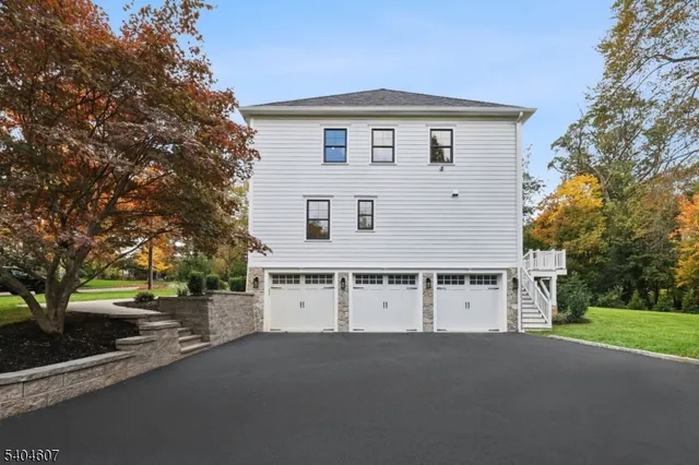 a view of a house with a yard and garage