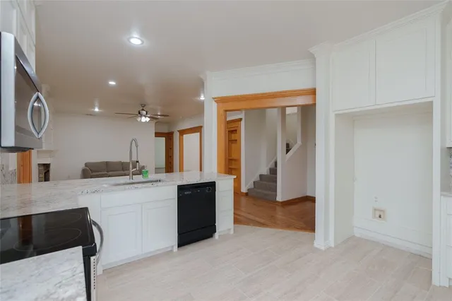 a large kitchen with a sink and a large window