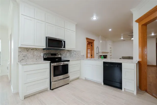 a kitchen with a sink stainless steel appliances and cabinets