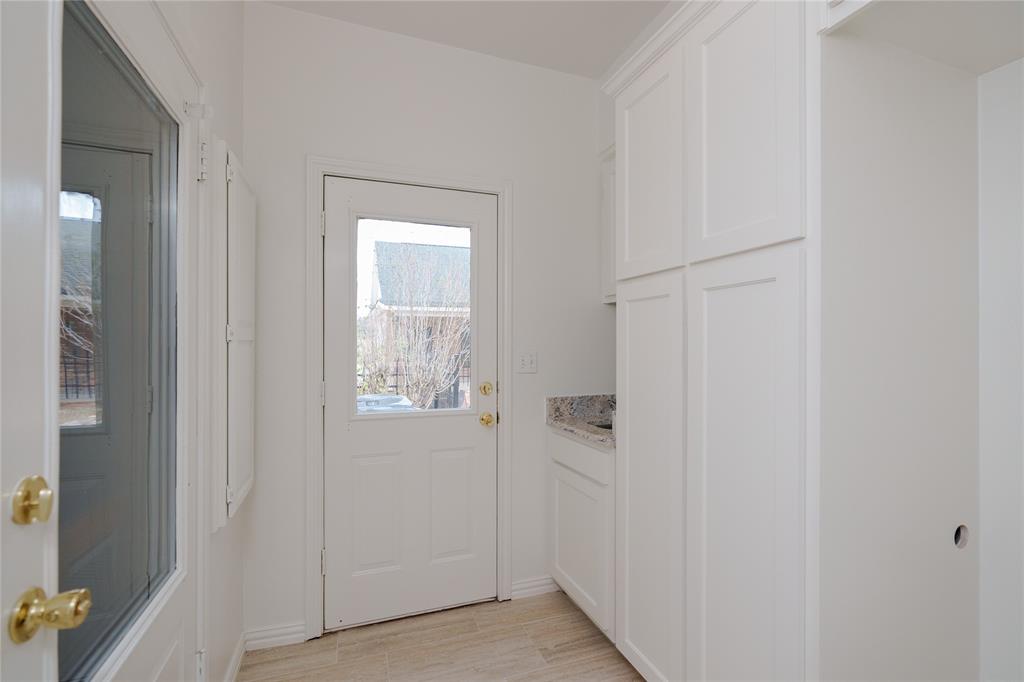 364 Parker Road Van Alstyne, TX 75495 - Photo 16 of 40 Full Size Stackable Washer Dryer Space with Cabinets and a sink.