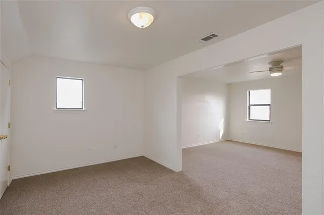 a view of an empty room with a ceiling fan