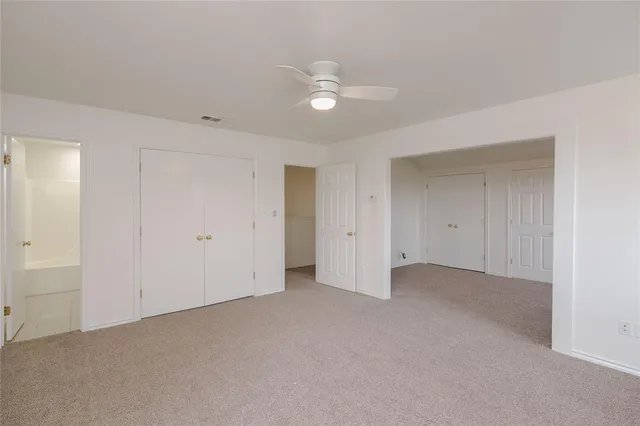 a bathroom with a tub shower sink and a toilet