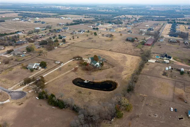 an aerial view of a house with a yard