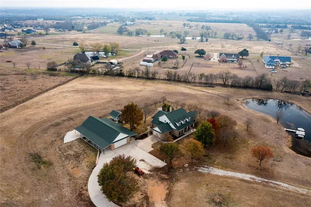 an aerial view of a house with outdoor space