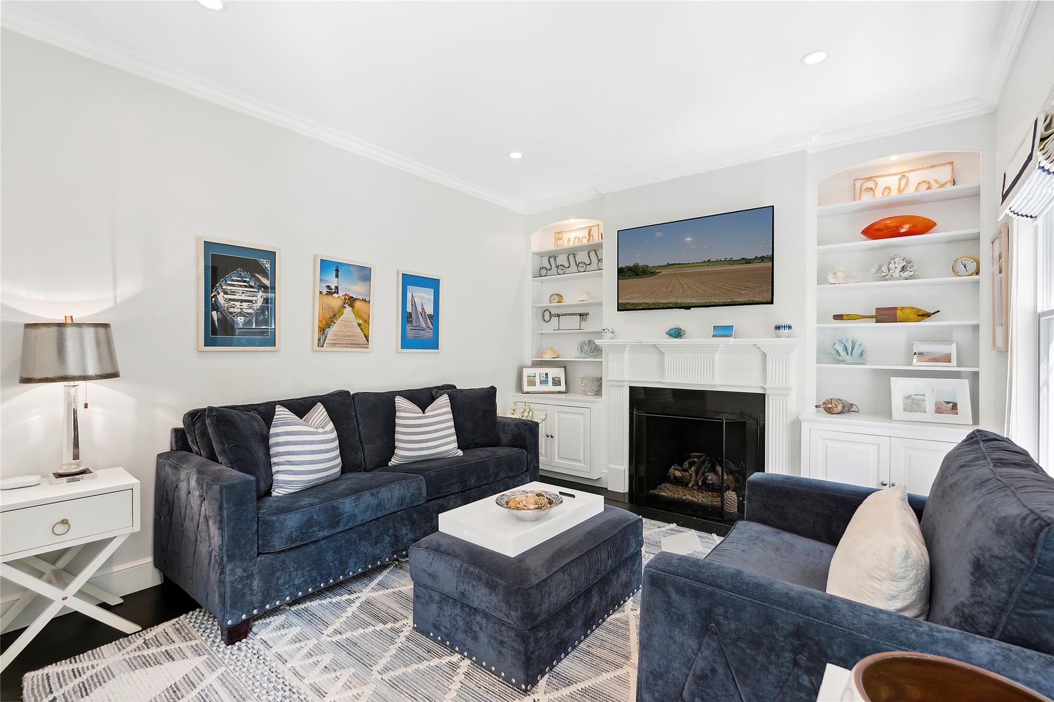 146 Coopers Farm Road Southampton, NY 11968 - Photo 3 of 25 a living room with furniture a flat screen tv and a fireplace