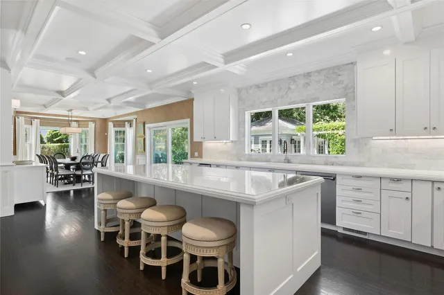 a kitchen with a table chairs stove and cabinets