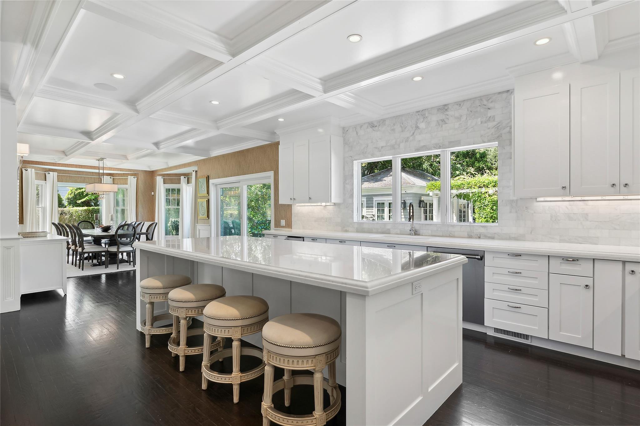 146 Coopers Farm Road Southampton, NY 11968 - Photo 9 of 25 a kitchen with a table chairs stove and cabinets