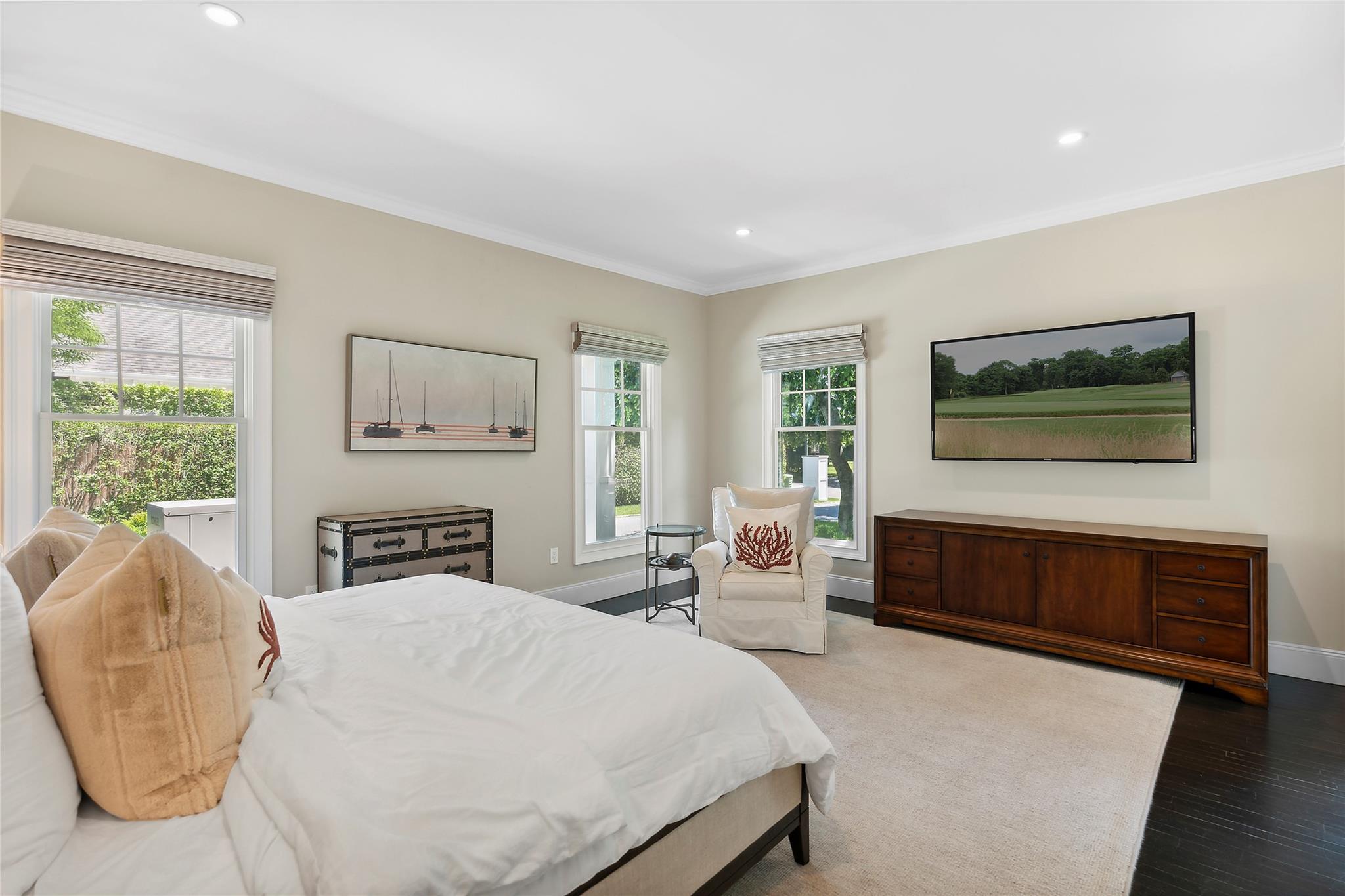 146 Coopers Farm Road Southampton, NY 11968 - Photo 10 of 25 a spacious bedroom with a bed a couch and large window