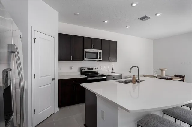 a kitchen with stainless steel appliances a refrigerator and a stove