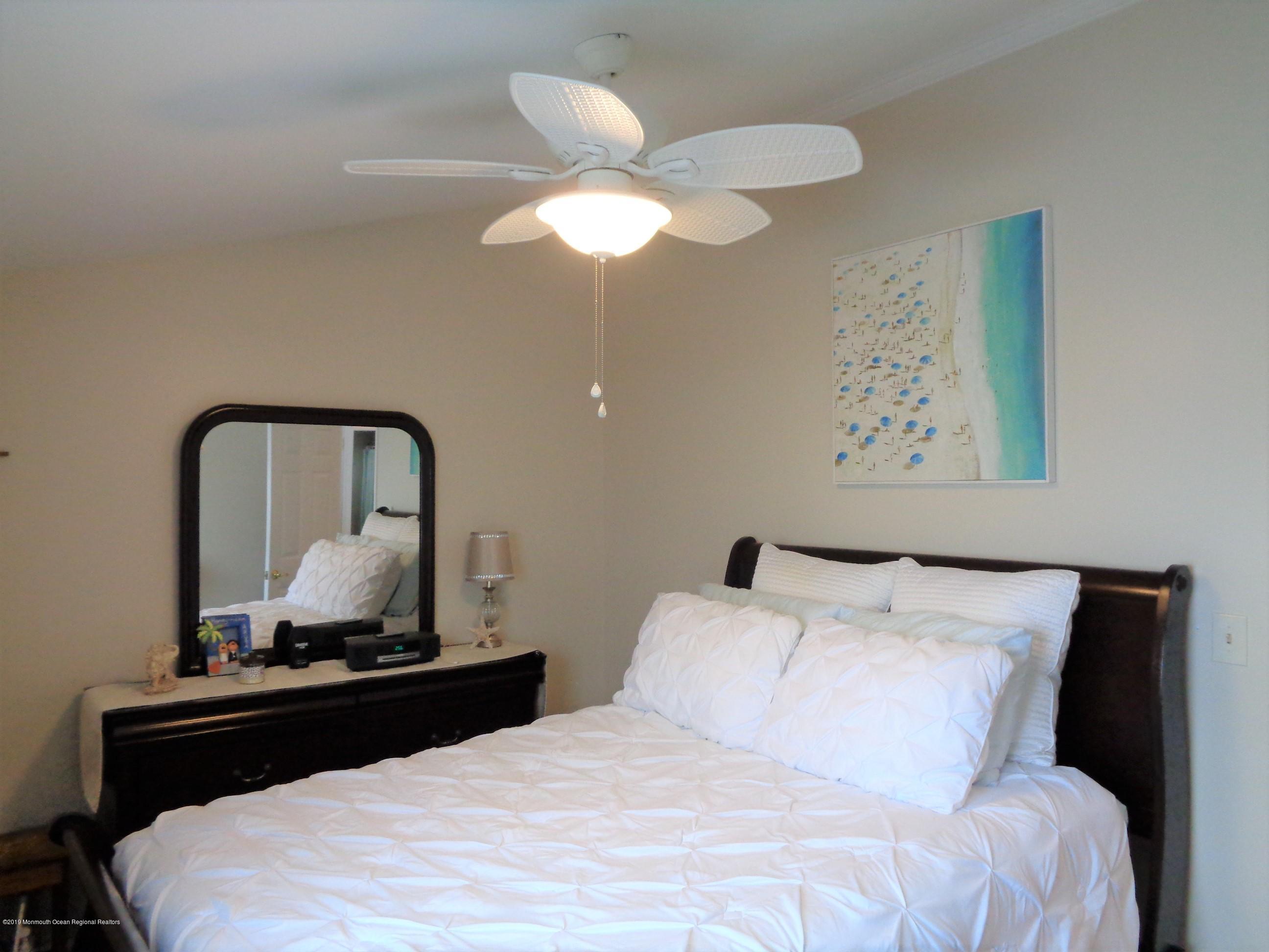 20 Capstan Road Waretown, NJ 08758 - Photo 14 of 25 a bedroom with a bed and a mirror