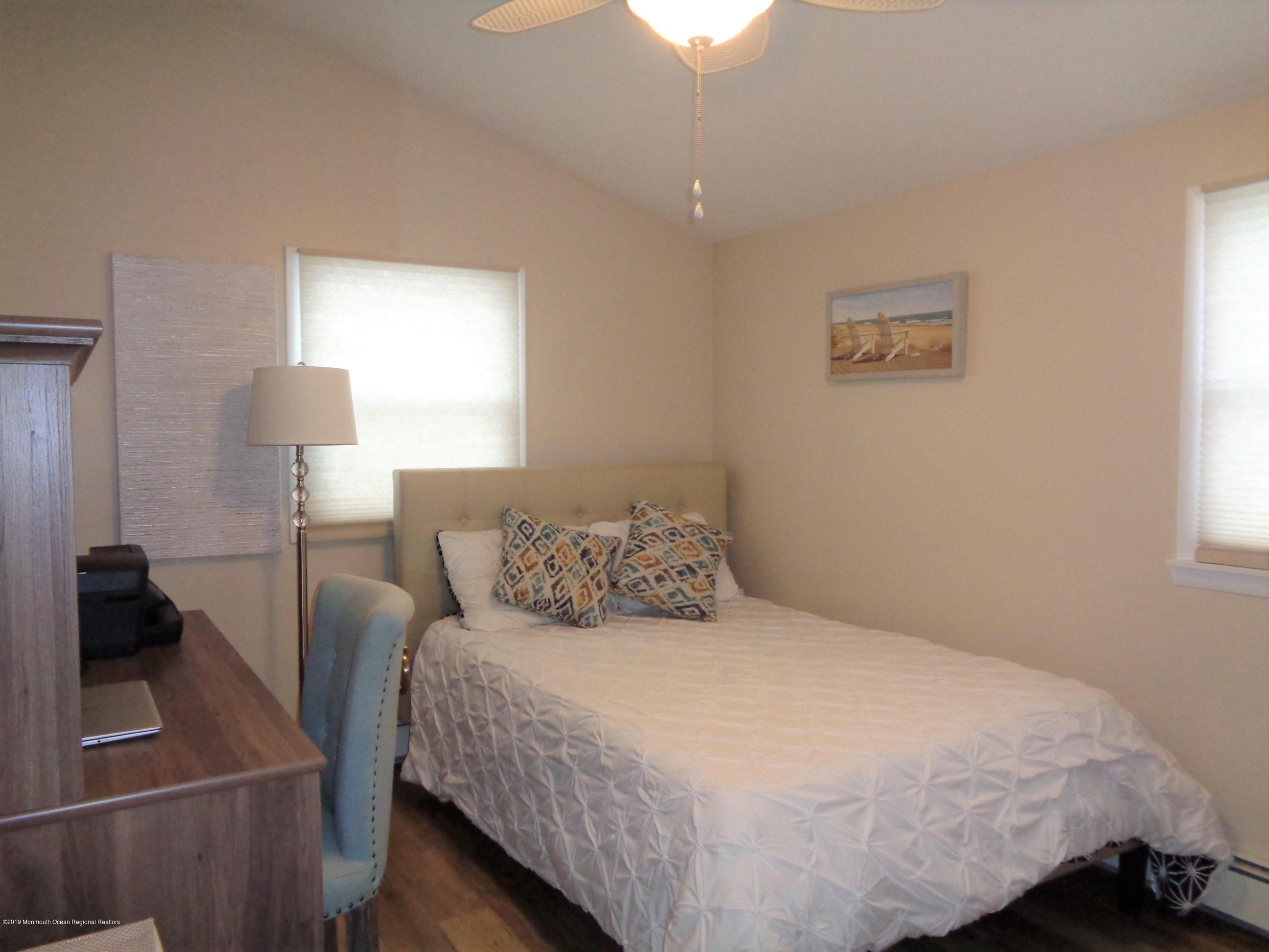 20 Capstan Road Waretown, NJ 08758 - Photo 15 of 25 a bedroom with a bed and a lamp
