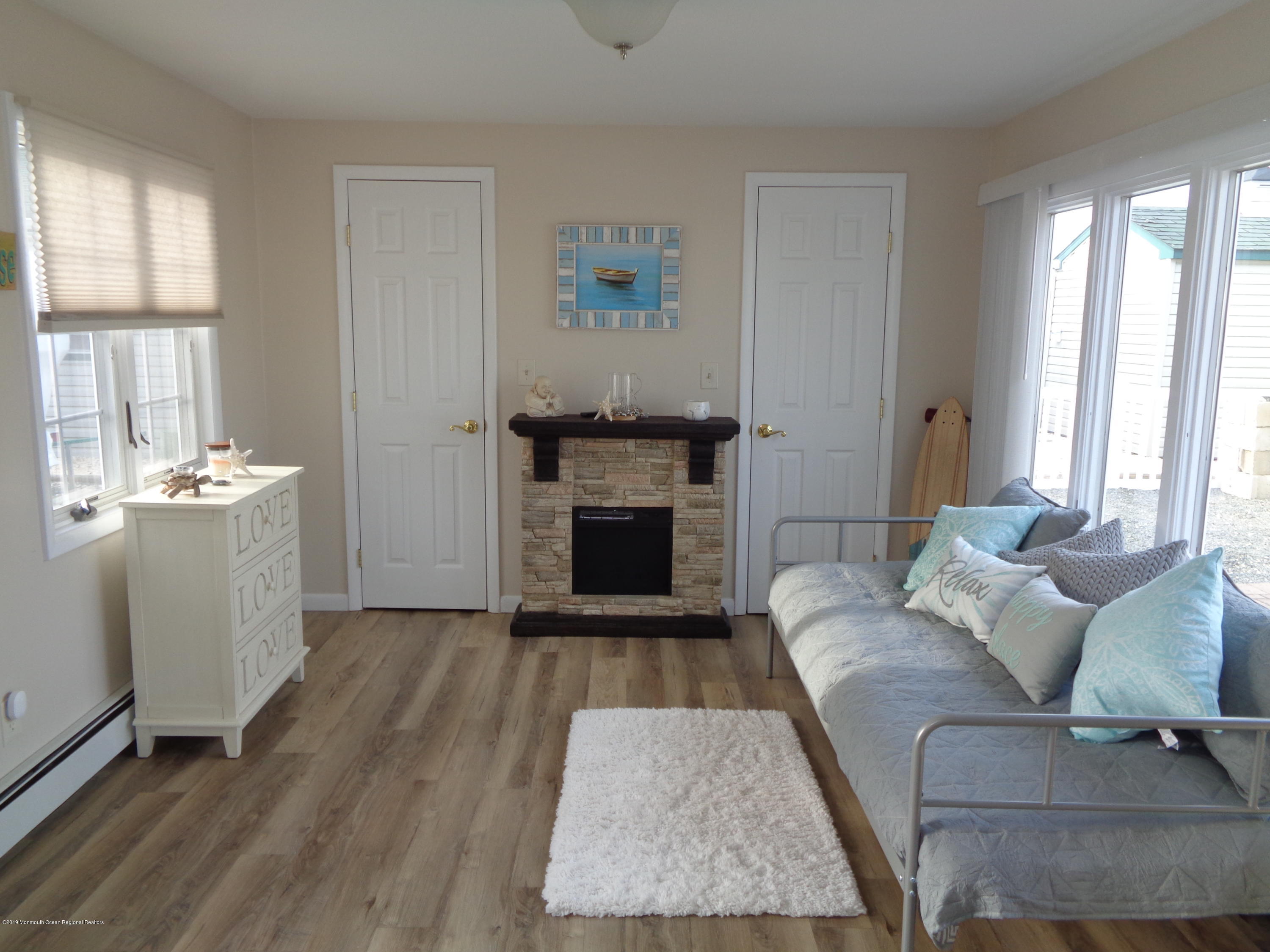 20 Capstan Road Waretown, NJ 08758 - Photo 4 of 25 a living room with furniture and a fireplace